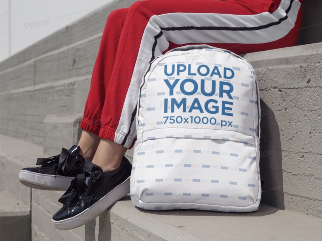 backpack mockup featuring a woman sitting on concrete bleachers