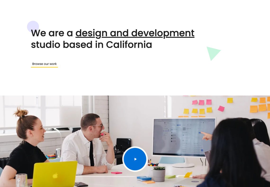 Creative Agency home page: the headline We are a design and development studio based in California above a wide photograph of a team meeting with a blue play button