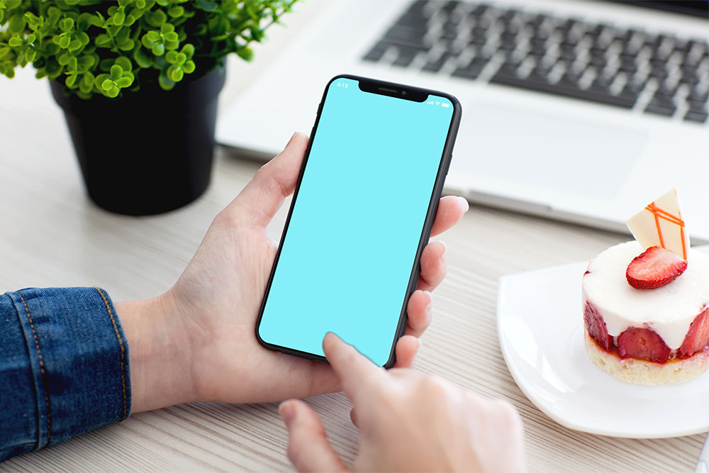 male hand holding iphone x psd mockup