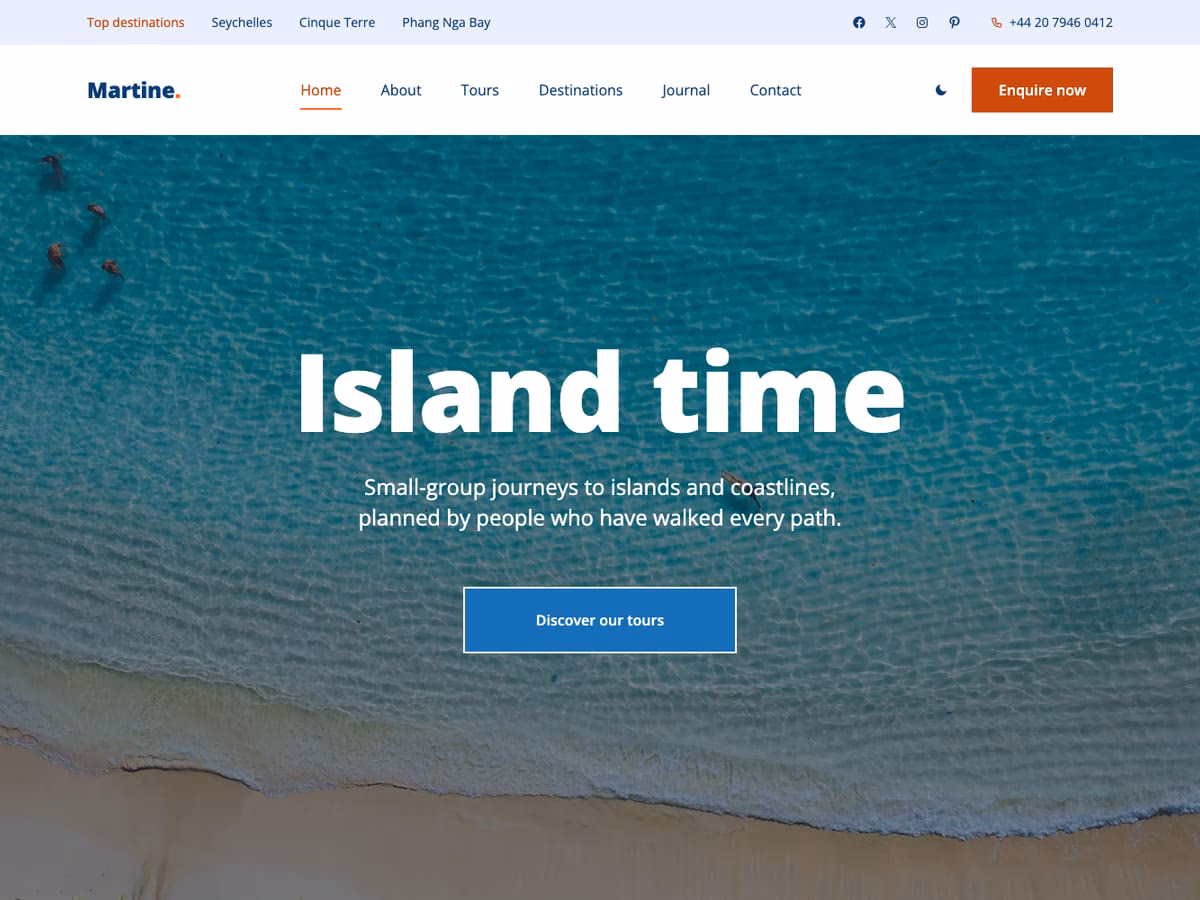 Martine WordPress theme home page: the white headline Island time over a beach and turquoise water seen from above, with a blue Discover our tours button