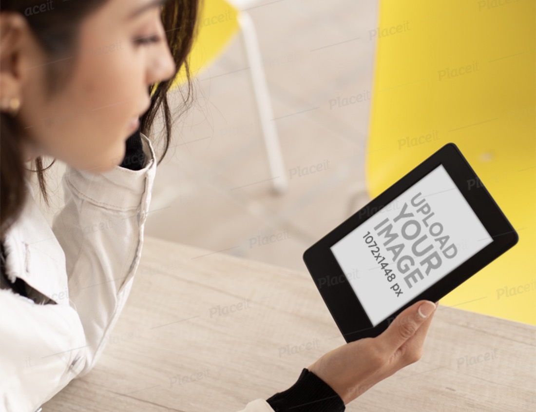 mockup of a woman on a table reading her kindle paperwhite