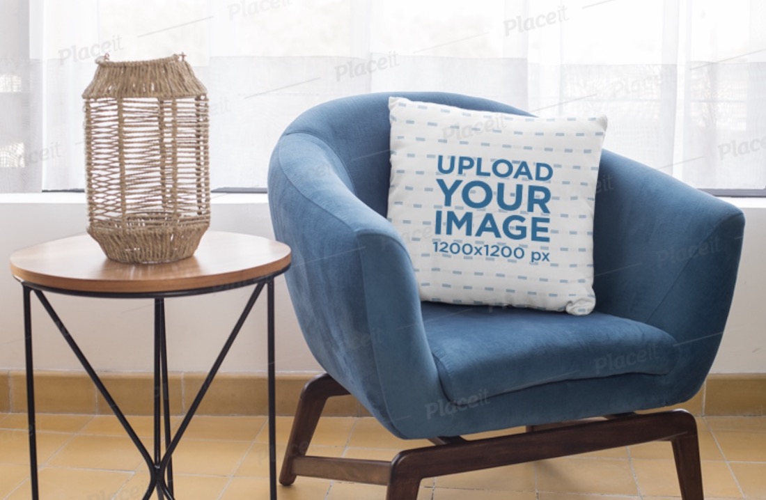 square pillow mockup on a blue single sofa