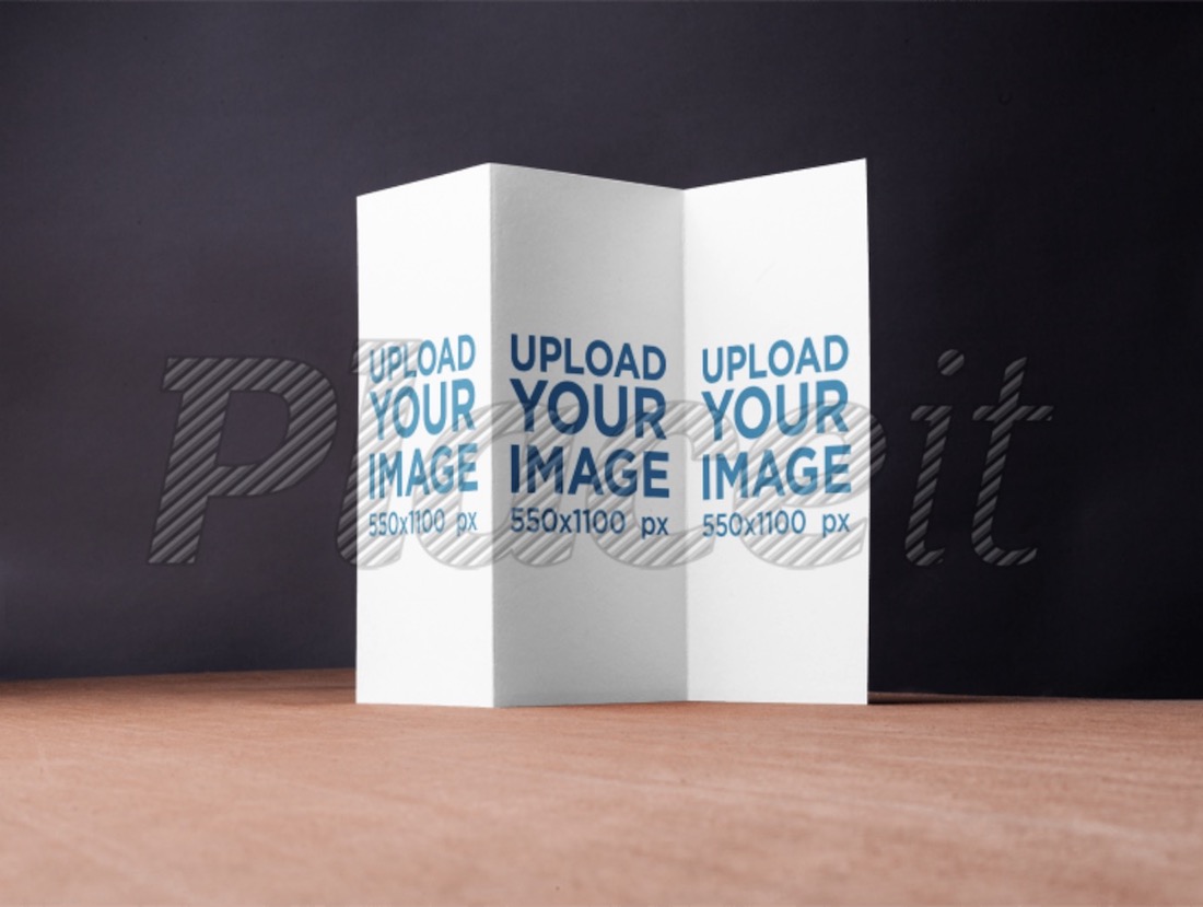 trifold brochure mockup on a wooden surface