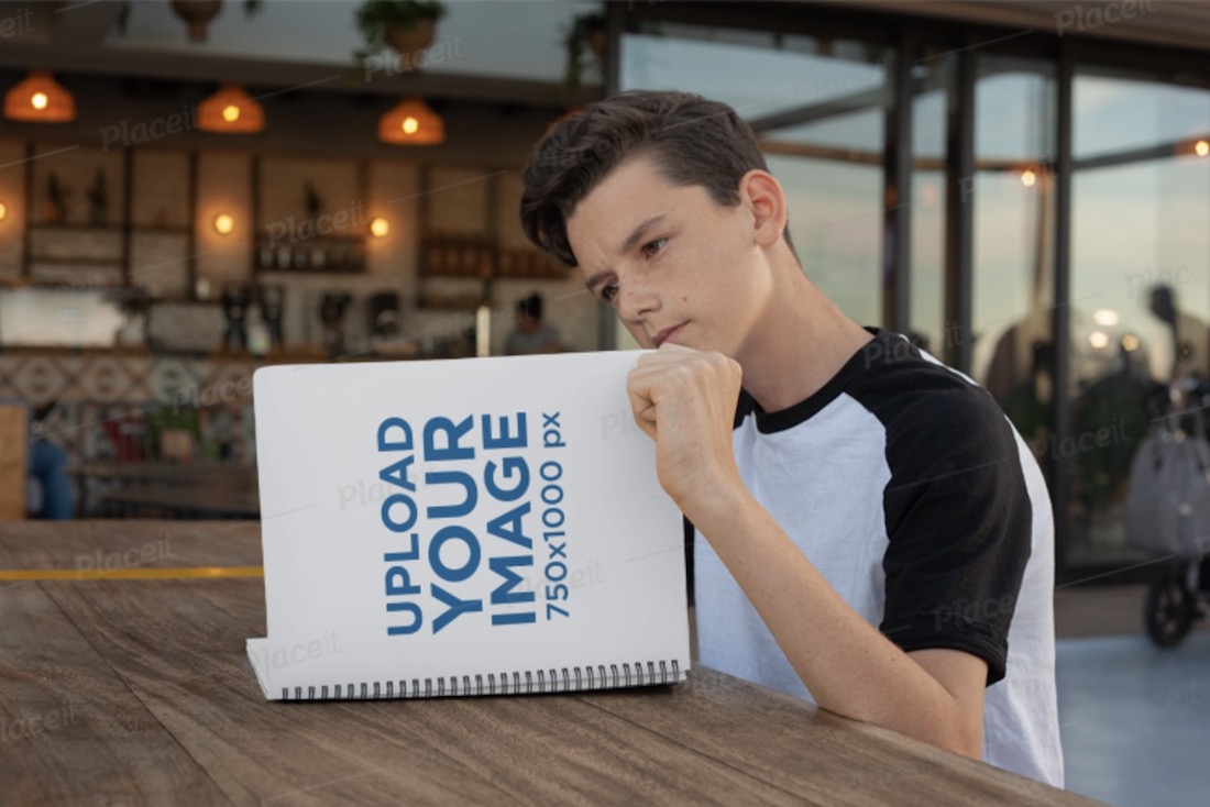 young boy reading notebook mockup