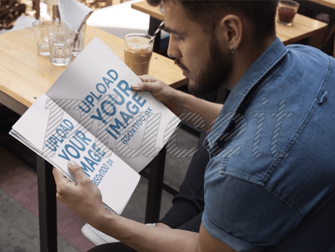 young man with beard reading a magazine mockup